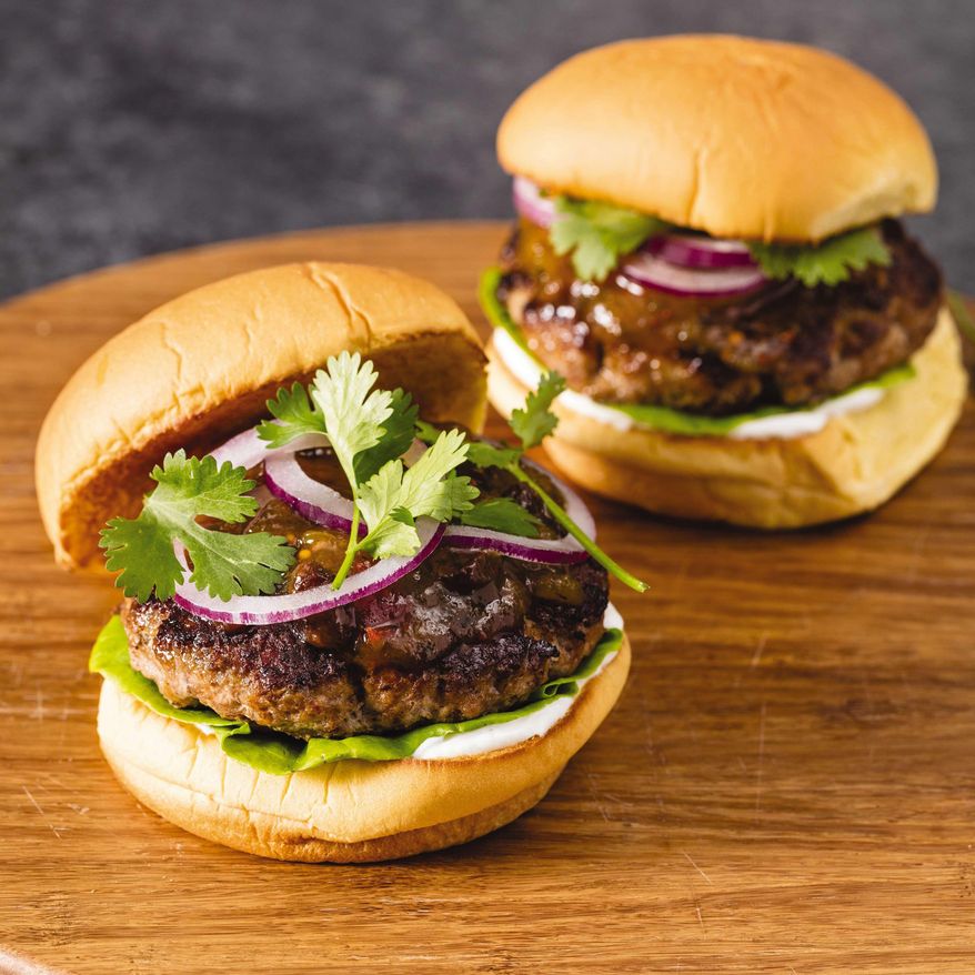 This undated photo provided by America's Test Kitchen in June 2019 shows Spiced Turkey Burgers with Mango Chutney in Brookline, Mass. This recipe appears in the cookbook “The Ultimate Burger.” (Daniel J. van Ackere/America's Test Kitchen via AP)