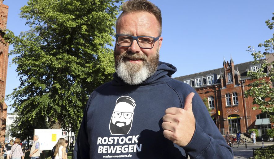 Mayor candidate Claus Ruhe Madsen, a Danish businessman, poses with thumb up at an election event of his team, during the counting of the votes for the mayor elections in the north-east German town Rostock, June 16, 2019. Claus Ruhe Madsen has been elected mayor of Rostock, becoming the first non-German citizen to head a large city in Germany. (Bernd Wuestneck/dpa via AP)
