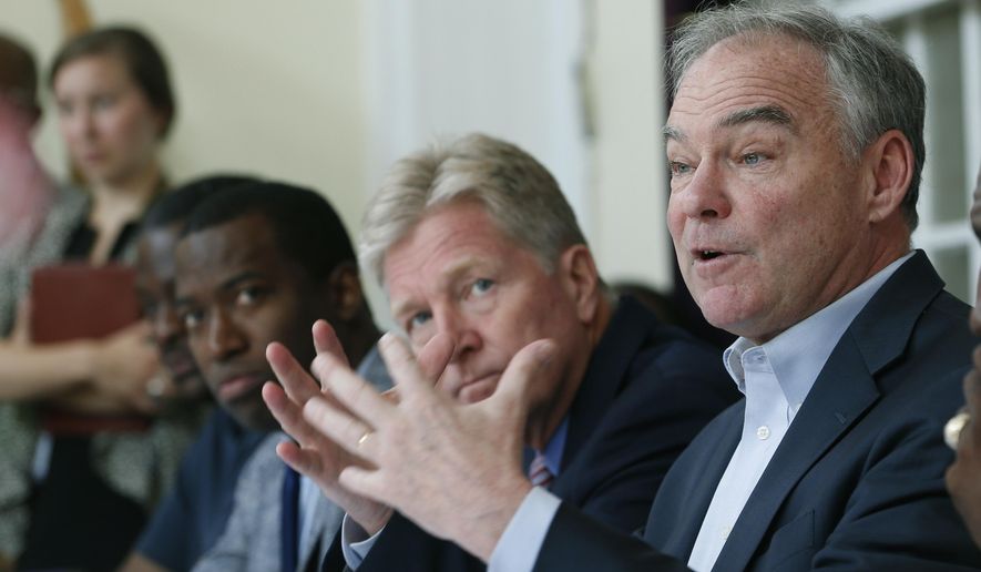 U.S. Sen. Tim Kaine, D-Va., right, gestures during a gun violence prevention roundtable discussion along with Richmond Mayor Levar Stoney, left, and Virginia Secretary of Public Safety, Brian Moran, center, in Richmond, Va., Monday, June 17, 2019. (AP Photo/Steve Helber) **FILE**