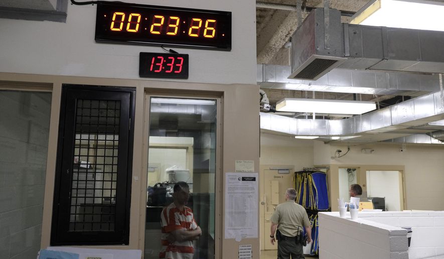 A clock at top counts down intervals between checks on inmates in the booking area holding cells at the Lake County Jail in Lakeport, Calif., on Tuesday, April 16, 2019. Major reforms were put in place at the jail following the 2015 suicide of a woman with a history of mental health problems who had repeatedly begged for help. Her son’s lawsuit resulted in $2 million wrongful death settlement. (AP Photo/Eric Risberg)
