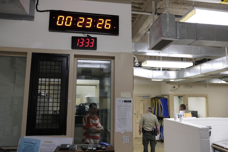 A clock at top counts down intervals between checks on inmates in the booking area holding cells at the Lake County Jail in Lakeport, Calif., on Tuesday, April 16, 2019. Major reforms were put in place at the jail following the 2015 suicide of a woman with a history of mental health problems who had repeatedly begged for help. Her son’s lawsuit resulted in $2 million wrongful death settlement. (AP Photo/Eric Risberg)