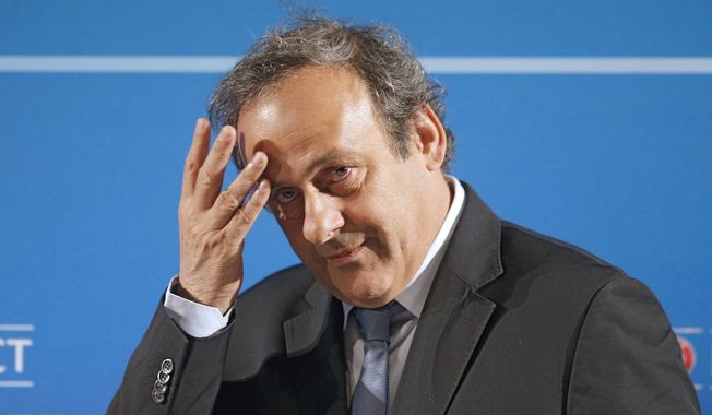  In this Feb.22, 2014 file photo, UEFA President Michel Platini arrives at a press conference, one day prior to the UEFA EURO 2016 qualifying draw in Nice, southeastern France. Former UEFA president Michel Platini has been arrested Tuesday June 18, 2019 over the awarding of the 2022 World Cup. (AP Photo/Lionel Cironneau, File) **FILE**