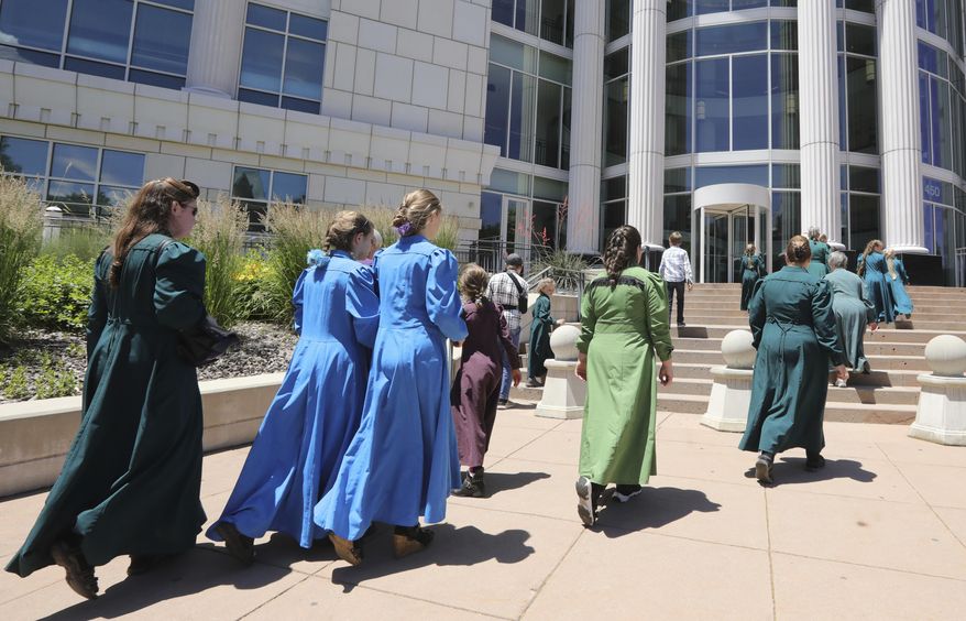 People arrive at the Matheson Courthouse Tuesday, June 18, 2019, in Salt Lake City. Members of a community on the Utah-Arizona border that is home to Warren Jeffs' polygamous sect are expected to raise concerns with a judge about favoritism and a lack of transparency by a board that oversees a former church trust that manages evictions and resales of homes and properties in the sister cities of Hildale, Utah, and Colorado City, Arizona. (AP Photo/Rick Bowmer)