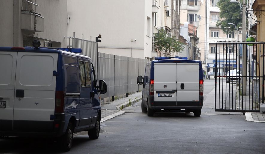 A detention vehicle is seen as it leaves a courthouse in Belgrade, Serbia, Tuesday, June 18, 2019. A Serbian court has acquitted a former U.S. Marine charged with illegal possession and distribution of weapons. The case of Daniel Corbett, reportedly a U.S. Navy SEAL reservist, has been in the focus of Serbian media since he was arrested in a Belgrade apartment along with three Serbs in January last year. (AP Photo/Darko Vojinovic)