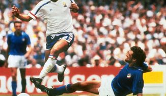 FILE - In this file photo dated  June 17, 1986, Michel Platini, left, of France dribbles past Italian forward Alessandro Altobelli in their World Cup eight finals in Mexico City&#39;s Azteca Stadium.  France won 2-0 to advance to the quarterfinals of the tournament and Italy was eliminated. Affectionately nicknamed “Le Roi” (The King), Michel Platini bestrode the soccer field with inimitable elegance as the world’s best player of the early 1980s, but his lofty reputation seems to have been tainted.  (AP Photo, FILE)