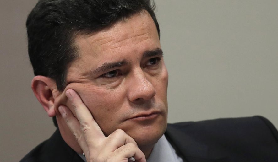 Brazil&#x27;s Justice Minister Sergio Moro listens to a question during his testimony before a senate commission, in Brasilia, Brazil, Wednesday, June 19, 2019.  Press reports have accused him of allegedly coordinating with prosecutors,  improperly advising them in a case against former President Luiz Inácio Lula da Silva. Moro and prosecutors deny any wrongdoing, but the Brazilian Bar Association has called for the suspension of the minister and others pending an inquiry. (AP Photo/Eraldo Peres)