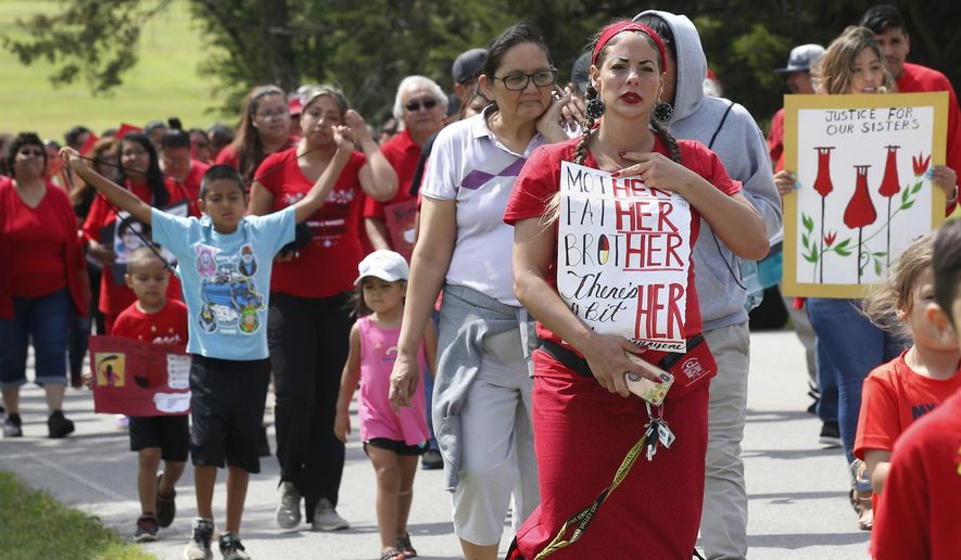 FILE - In this Friday, June 14, 2019, file photo, Miranda Muehl, of Mustang, Okla., marches during a march to call for justice for missing and murdered indigenous women at the Cheyenne and Arapaho Tribes of Oklahoma in Concho, Okla. A key congressional committee is holding a hearing on a slate of legislation aimed at addressing the deaths and disappearances of Native American women. The bills before the U.S. Senate Committee on Indian Affairs would require law enforcement to submit annual reports to Congress to give lawmakers a better handle on the number of cases. (AP Photo/Sue Ogrocki, File)