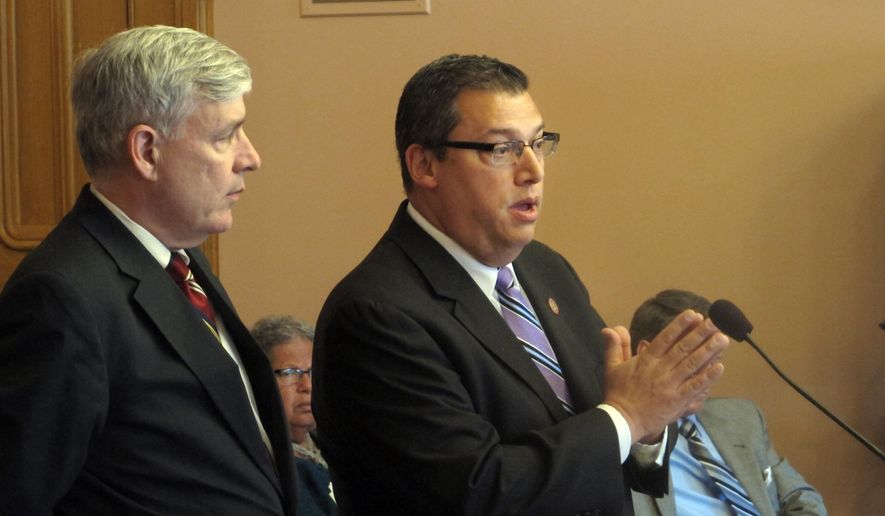In this May 6, 2015 file photo, State Rep. Ron Hood, right, answers a question about his proposal to allow residents to carry a concealed weapon without first having to have a permit, with his co-sponsor, Rep. Tom Brinkman in Columbus, Ohio. An Ohio House committee has scheduled a vote on legislation allowing individuals to carry concealed weapons without having to receive training, undergo a background check or obtain a license. The House Federalism Committee meets Wednesday, June 19, 2019 on the bill sponsored by Hood and Brinkman, both Republicans. (AP Photo/Andrew Welsh-Huggins, File) **FILE**