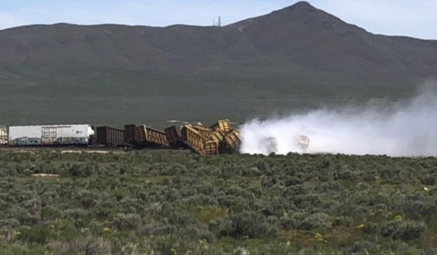 In this photo provided by Michael Lyday shows a train derailment and potential hazardous materials spill east of Wells, Nev., Wednesday, June 19, 2019. A 60-mile stretch (96 kilometers) of U.S. Interstate 80 in northeast Nevada has been closed while emergency crews respond to the train derailment and potential hazardous materials spill east of Wells. (Michael Lyday via AP)