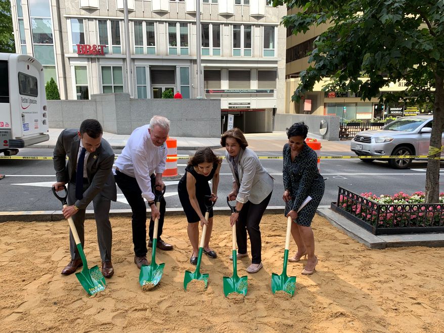 D.C. officials break ground for 10 rain gardens and nine tree boxes at K and 19th streets NW on Thursday. (From left: Jeff Marootian, director of the District Department of Transportation; Tommy Wells, director of the District Department of Energy; Leona Agouridis, executive director of the Golden Triangle Business Improvement District; D.C. Council member Mary Cheh, Ward 3 Democrat; and Donna Cooper, president of Pepco Holdings. (Ximena Bustillo/ The Washington Times)