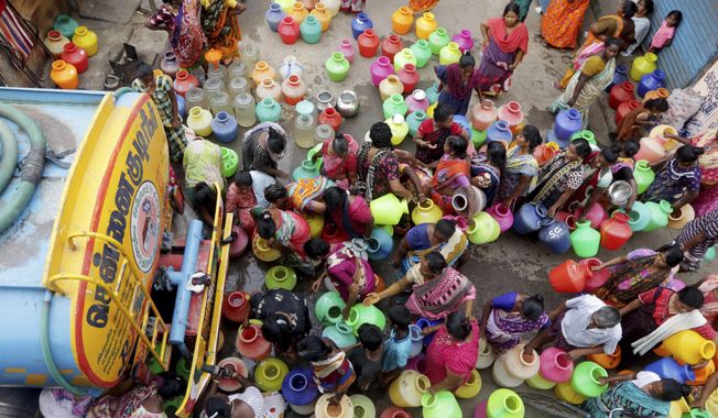 Indiand stand in queues to fill vessels filled with drinking water from a water tanker in Chennai, capital of the southern Indian state of Tamil Nadu, Wednesday, June 19, 2019. Millions of people are turning to water tank trucks in the state as house and hotel taps run dry in an acute water shortage caused by drying lakes and depleted groundwater. Some private companies have asked employees to work from home and several restaurants are closing early and even considering stopping lunch meals if the water scarcity aggravates. (AP Photo/R. Parthibhan)