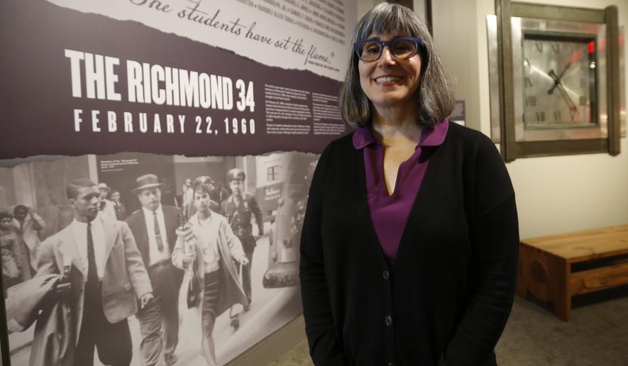 Karen Sherry, Curator of Exhibitions for the Virginia Museum of History &amp;amp; Culture, stands next one of the opening exhibits for the exhibit titled Determined The 400-year struggle for Black Equality at the museum in Richmond, Va., Wednesday, June 19, 2019. The exhibit is scheduled to open June 22. (AP Photo/Steve Helber)