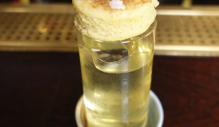 A picture of a Petit DJ Ne cocktail, at the Rosewood hotel in London, Wednesday, June 19, 2019. The martini's heyday began almost a century ago, but today's bartenders have some innovative takes on the classic cocktail. (AP Photo/Sian Watson)