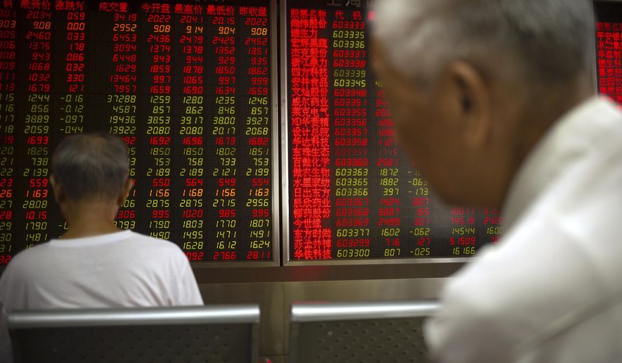 Chinese investors monitor stock prices at a brokerage house in Beijing, Thursday, June 20, 2019. Asian shares were higher on Thursday, with the Shanghai benchmark up 2.6%, after the Federal Reserve reaffirmed that it’s prepared to cut interest rates if needed to shield the U.S. economy from trade conflicts or other threats. (AP Photo/Mark Schiefelbein)