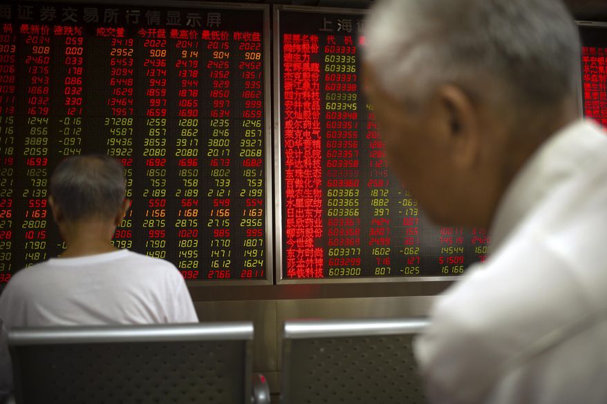Chinese investors monitor stock prices at a brokerage house in Beijing, Thursday, June 20, 2019. Asian shares were higher on Thursday, with the Shanghai benchmark up 2.6%, after the Federal Reserve reaffirmed that it’s prepared to cut interest rates if needed to shield the U.S. economy from trade conflicts or other threats. (AP Photo/Mark Schiefelbein)