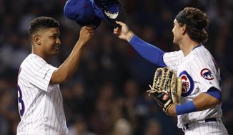 Chicago Cubs&#39; Adbert Alzolay, left, is congratulated by Albert Almora Jr. on his first win in the majors, against the New York Mets in a baseball game Thursday, June 20, 2019, in Chicago. The Cubs won 7-4.(AP Photo/Jim Young)