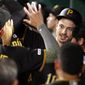 Pittsburgh Pirates&#39; Bryan Reynolds, right, celebrates in the dugout after hitting a three-run home run off Detroit Tigers relief pitcher Nick Ramirez during the sixth inning of a baseball game in Pittsburgh, Wednesday, June 19, 2019. (AP Photo/Gene J. Puskar)