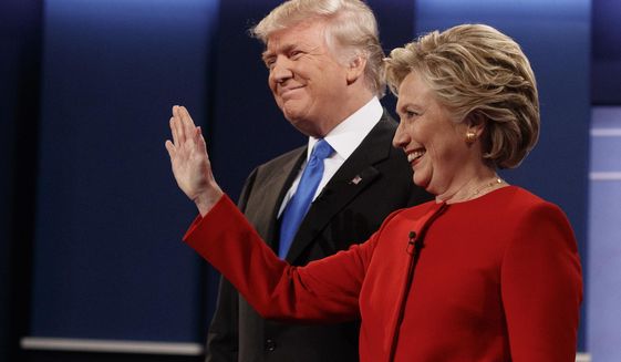In this Sept. 26, 2016 file photo, then Republican presidential candidate Donald Trump, left, stands with then Democratic presidential candidate Hillary Clinton before the first presidential debate at Hofstra University in Hempstead, N.Y. Gearing up to take on Democratic front-runner Joe Biden, President Donald Trump sees echoes of his original political foe, Hillary Clinton. (AP Photo/ Evan Vucci)