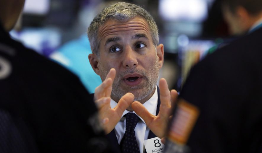 FILE - In this June 11, 2019, file photo specialist Anthony Rinaldi talks with colleagues on the floor of the New York Stock Exchange. The U.S. stock market opens at 9:30 a.m. EDT on Friday, June 21. (AP Photo/Richard Drew, File)