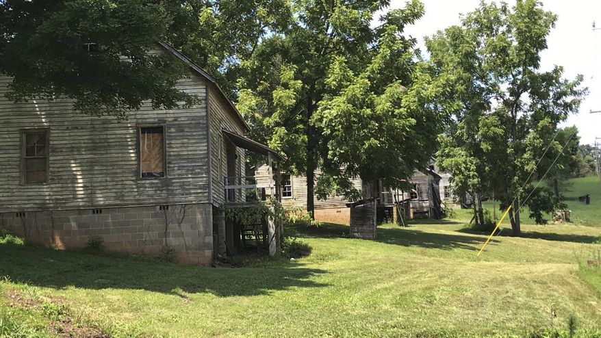 This undated photo made available by Calvin Reyes, shows buildings in an abandoned mill village near Asheville, NC., that was used in the first "Hunger Games" movie. The village is now a historic site. The designation for the Henry River Mill Village was announced earlier this week. (Calvin Reyes via AP)
