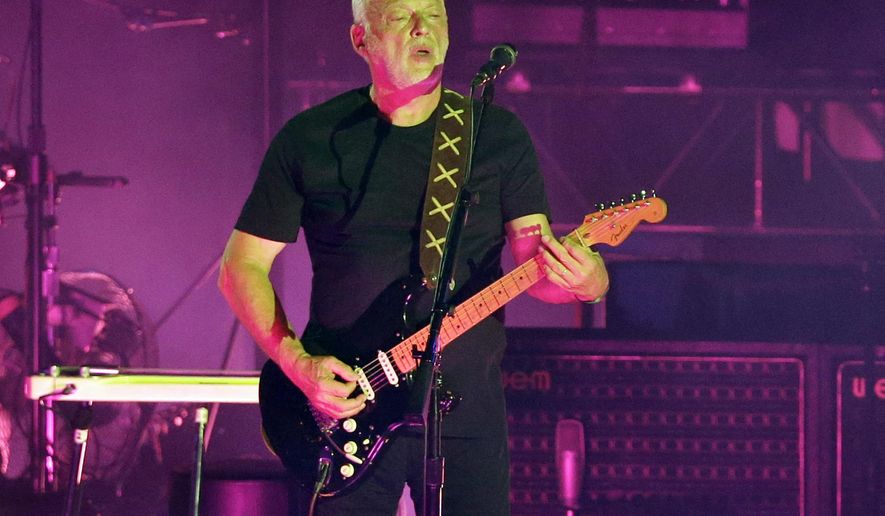FILE - In this July 7, 2016, file photo, musician David Gilmour performs in the ancient roman amphitheater of the Pompeii archeological site, Italy. Christie’s auction house says it raised $21.5 million Thursday, June 20, 2019, selling off more than 120 guitars owned by the Pink Floyd guitarist, singer and songwriter. Proceeds went to ClientEarth, a non-profit fighting climate change. A black Stratocaster, dubbed the “Black Strat”, was the top item and was snatched up for $3,975,000, a new world record for a guitar at auction. (AP Photo/Gregorio Borgia, File)