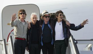 FILE - In this March 24, 2016 file photo, members of The Rolling Stones, from left, Mick Jagger, Charlie Watts, Keith Richards and Ron Wood pose for photos from the plane that brought them to Cuba at Jose Marti international airport in Havana, Cuba. The band plays Friday, June, 21, 2019 at Soldier Field in Chicago after a postponing their North American tour because frontman Mick Jagger needed medical treatment. A second show is scheduled for Tuesday at Soldier Field. (AP Photo/Ramon Espinosa File)