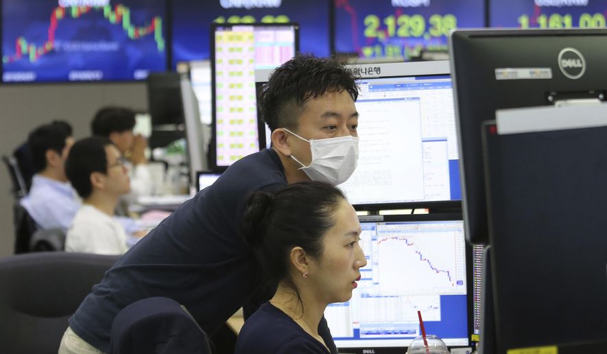 Currency traders watch monitors at the foreign exchange dealing room of the KEB Hana Bank headquarters in Seoul, South Korea, Friday, June 21, 2019. Shares retreated in Asia on Friday after a broad rally for stocks drove the S&P 500 index to an all-time high as weak manufacturing data from Japan helped dampen investor sentiment. (AP Photo/Ahn Young-joon)