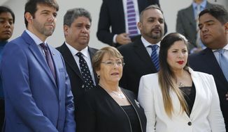 U.N. High Commissioner for Human Rights Michelle Bachelet poses for a photo with opposition lawmakers on the steps of the national assembly in Caracas, Venezuela, Friday, June 21, 2019. The United Nations&#39; top human rights official is visiting Venezuela amid heightened international pressure on President Nicolás Maduro. (AP Photo/Ariana Cubillos)