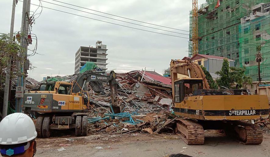 In this photo provided by Cambodia National Police, backhoes work near a site of a collapse in Preah Sihanouk province, Cambodia Saturday, June 22, 2019. A seven-story building under construction collapsed, killing at least a few workers, authorities said. (Cambodia National Police via AP)