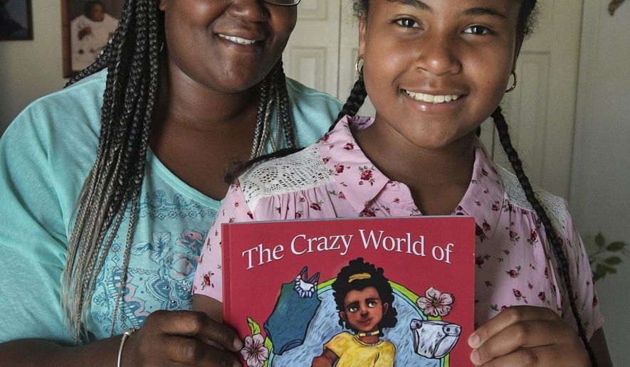 In this May 9, 2019 photo, E'yannie Gomez stands with her mother, Shantia Benson , in Bradenton, Fla. E'yannie, a fourth-grader at Samoset Elementary School, wrote "The Crazy World of Alexa," with the help of her mother. When E’yannie began writing stories in a journal, Shantia Benson, suggested she start with things that happened in real life. They worked together on those stories. They produced enough copy for a book and found a Tampa company to help them publish it. (Dan Wagner/Sarasota Herald-Tribune via AP)