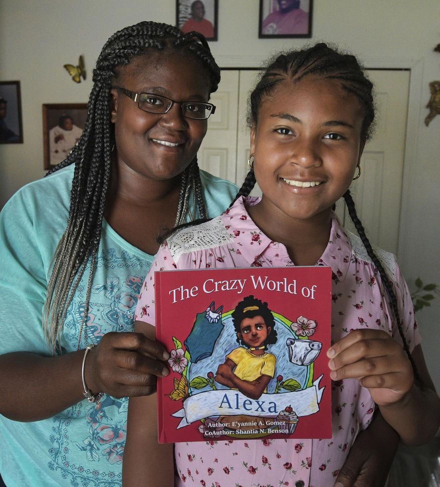 In this May 9, 2019 photo, E'yannie Gomez stands with her mother, Shantia Benson , in Bradenton, Fla. E'yannie, a fourth-grader at Samoset Elementary School, wrote "The Crazy World of Alexa," with the help of her mother. When E’yannie began writing stories in a journal, Shantia Benson, suggested she start with things that happened in real life. They worked together on those stories. They produced enough copy for a book and found a Tampa company to help them publish it. (Dan Wagner/Sarasota Herald-Tribune via AP)