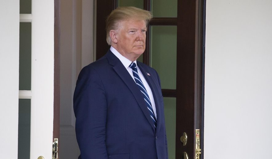 In this June 20, 2019, photo, President Donald Trump awaits the arrival of Canadian Prime Minister Justin Trudeau to the White House in Washington. (AP Photo/Alex Brandon) ** FILE **