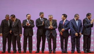 From left, Malaysia Foreign Minister Saifuddin Abdullah, Myanmar Minister of State for Foreign Affaires Kyaw Tin, Philippines Foreign Affaires Secretary Teodoro Locsin Jr., Singapore Foreign Minister Vivian Balakrishnan, Thailand Foreign Minister Don Pramudwinai, Vietnam Foreign Minister Pham Binh Minh, Brunei Second Minister of Foreign affaires and Trade Erywan Yusof, and Cambodia Foreign Minister Prak Sokhonn clap after posing for a group photo during the Association of Southeast Asian Nations (ASEAN) Foreign Ministers&#39; meeting in Bangkok, Thailand, Saturday, June 22, 2019. (AP Photo/Gemunu Amarasinghe)