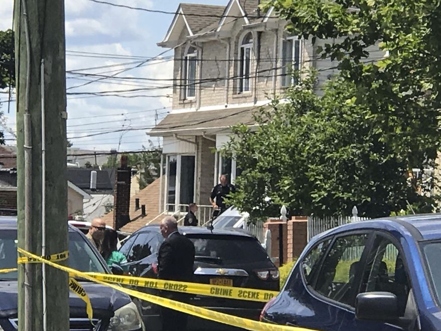 Police work the scene in the South Beach section of the Staten Island borough of New York, Saturday, June 22, 2019, after a woman and two small children were found dead in a neighborhood home. Police say a 37-year-old woman and two boys ages 2 and 3 were found dead Saturday morning. The victims' names have not been released. Police say that they have a person in custody. (Irene Spezzamonte/Staten Island Advance via AP)