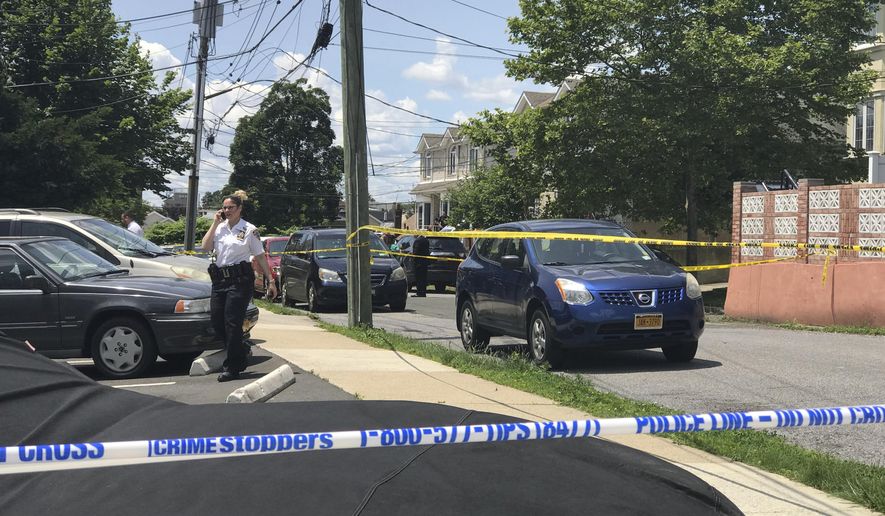 Crime scene tape cordons off an area in the South Beach section of the Staten Island borough of New York, Saturday, June 22, 2019, after a woman and two small children were found dead in a neighborhood home. Police say a 37-year-old woman and two boys ages 2 and 3 were found dead Saturday morning. The victims' names have not been released. (Irene Spezzamonte/Staten Island Advance via AP)