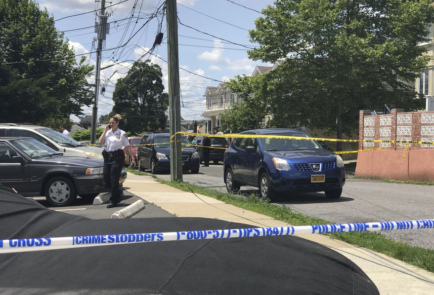 Crime scene tape cordons off an area in the South Beach section of the Staten Island borough of New York, Saturday, June 22, 2019, after a woman and two small children were found dead in a neighborhood home. Police say a 37-year-old woman and two boys ages 2 and 3 were found dead Saturday morning. The victims' names have not been released. (Irene Spezzamonte/Staten Island Advance via AP)