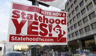 Signs supporting D.C. statehood are on display outside an early voting place on in Washington, Thursday, Nov. 3, 2016. (AP Photo/Susan Walsh) **FILE**
