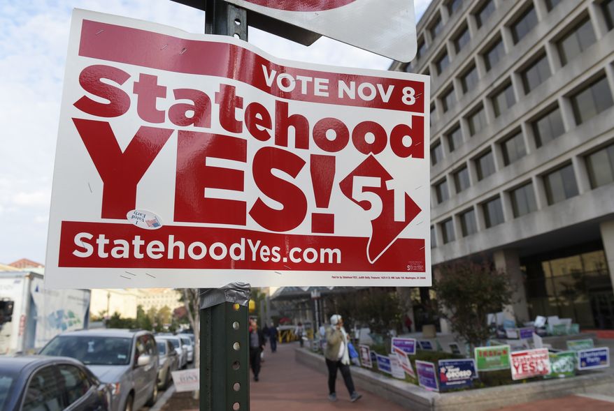 Signs supporting D.C. statehood are on display outside an early voting place on in Washington, Thursday, Nov. 3, 2016. (AP Photo/Susan Walsh) **FILE**