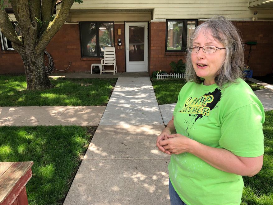In this June 14, 2019 photo, Marti Poll, 55, discusses her struggle to get health care for a variety of conditions outside her apartment complex outside of Lincoln, Nebraska. Poll is one of the estimated 90,000 people who could get coverage under the Medicaid expansion measure approved by voters in November, but some critics say state officials are taking too long to launch the program. (AP Photo/Grant Schulte)