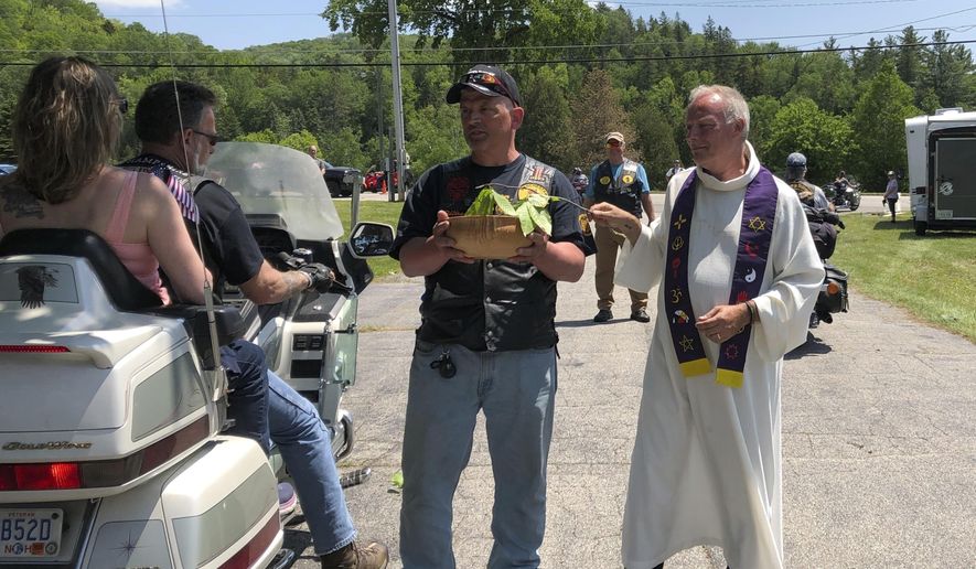 Motorcyclists participate in a "Blessing of the Bikes" ceremony in Columbia, N.H., Sunday, June 23, 2019. While such ceremonies are periodically held, the Sunday event held special meaning for the motorcycle community. Bikers and veterans are reeling from a crash, in which a pickup truck towing a flatbed trailer collided with a group of 10 motorcycles Friday evening. (AP Photo/Lisa Rathke)