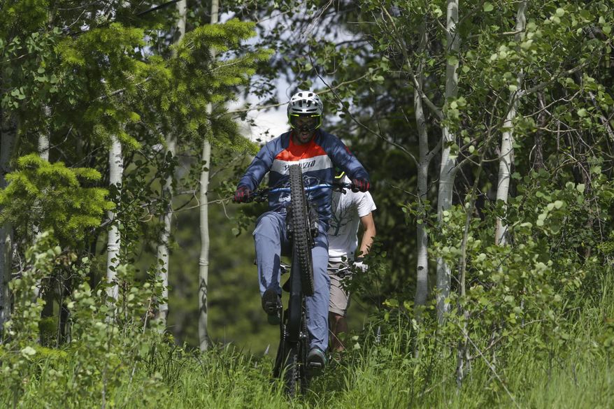 In this Tuesday, June 18, 2019 photo, Colton Lee rides a trail at Kelly Canyon Ski Resort in Ririe, Idaho. "It's really cool, said Lee. "It's a good addition to the mountain bike scene." Kelly Canyon has built 30 named trails totalling 19 miles of riding available via chairlift. "The goal is to not have to pedal too much," said David Stoddard "its gravity riding." The park will be open Saturday, June 29th with bikes available to rent. (John Roark/The Idaho Post-Register via AP)