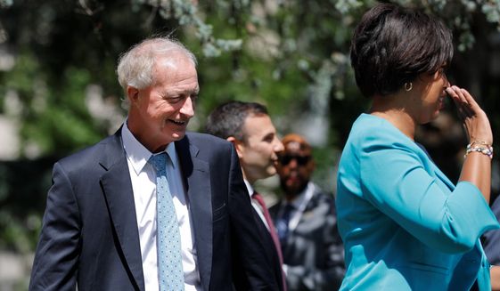  In this May 31, 2019, photo, Washington Metropolitan Area Transit Authority Chair and D.C. Council Member Jack Evans joins D.C., Mayor Muriel Bowser, right, at the podium during a news conference announcing a dedicated bus lane in downtown Washington. (AP Photo/Pablo Martinez Monsivais) **FILE**