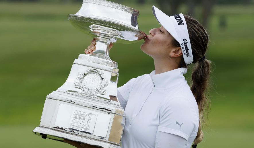 Hannah Green, of Australia, kisses the trophy after winning the KPMG Women's PGA Championship golf tournament, Sunday, June 23, 2019, in Chaska, Minn. (AP Photo/Charlie Neibergall)