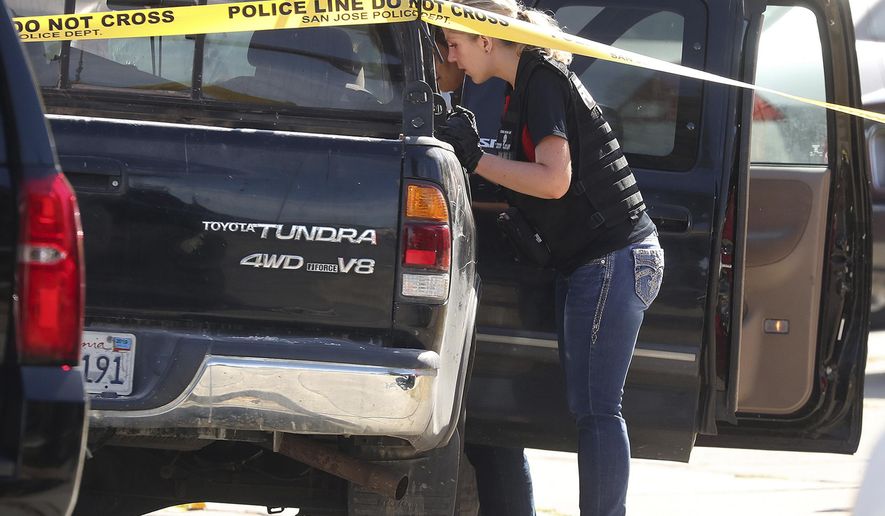 A forensic analyst with the San Jose Police Department searches a truck near scene where five people were killed Monday, June 24, 2019, in San Jose, Calif. A gunman shot and killed four people then turned the gun on himself after an hours-long standoff with police in California, authorities said Monday. San Jose police saw several family members fleeing a home when police responded to multiple calls of shots fired Sunday night. (Aric Crabb/Bay Area News Group via AP)