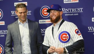 FILE - In this June 7, 2019, file photo, Chicago Cubs President Theo Epstein, left, introduces pitcher Craig Kimbrel during a news conference at Wrigley Field in Chicago. New Cubs closer Craig Kimbrel is at Triple-A Iowa, preparing to join the Cubs as they shoot for the N.L. Central crown.(Jose M. Osorio/Chicago Tribune via AP, File)