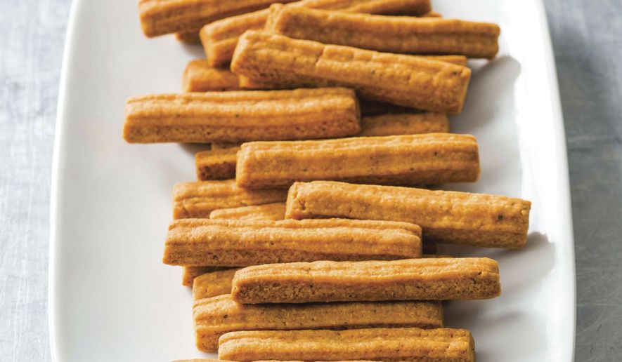 This undated photo provided by America's Test Kitchen in June 2019 shows Southern Cheese Straws in Brookline, Mass. This recipe appears in the cookbook “Spiced.” (Joe Keller/America's Test Kitchen via AP)