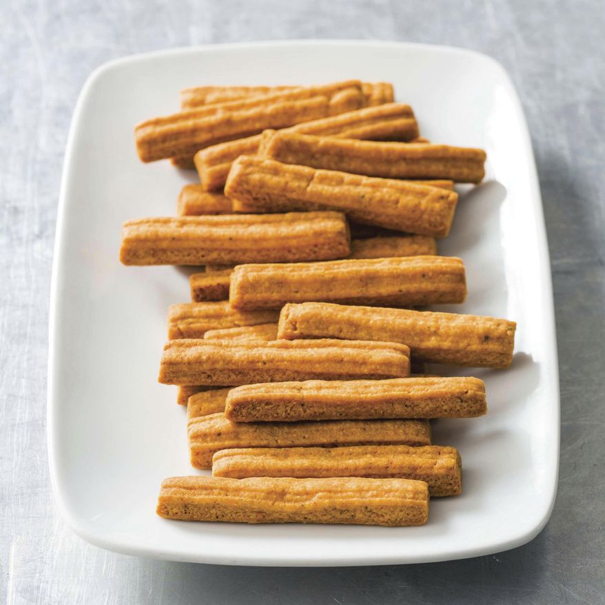 This undated photo provided by America's Test Kitchen in June 2019 shows Southern Cheese Straws in Brookline, Mass. This recipe appears in the cookbook “Spiced.” (Joe Keller/America's Test Kitchen via AP)