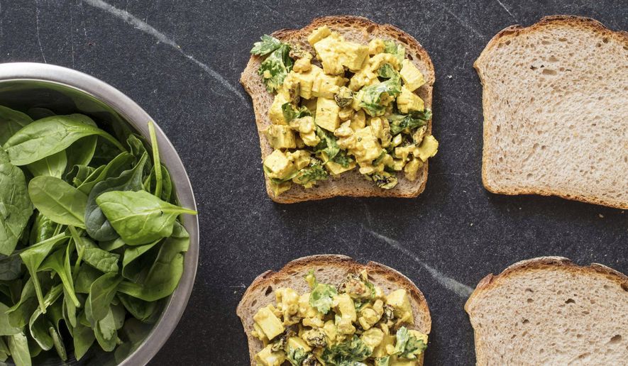 This undated photo provided by America's Test Kitchen in June 2019 shows Turmeric Chicken Salad Sandwiches in Brookline, Mass. This recipe appears in the cookbook “Nutritious Delicious.” (Daniel J. van Ackere/America's Test Kitchen via AP)