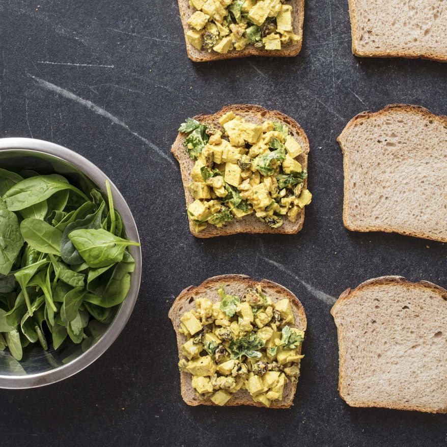 This undated photo provided by America's Test Kitchen in June 2019 shows Turmeric Chicken Salad Sandwiches in Brookline, Mass. This recipe appears in the cookbook “Nutritious Delicious.” (Daniel J. van Ackere/America's Test Kitchen via AP)