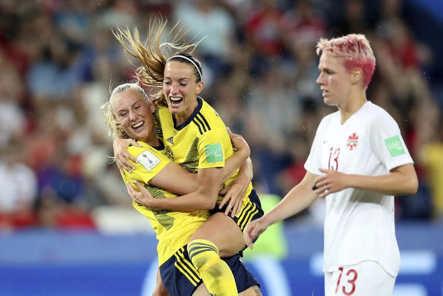 Sweden's Stina Blackstenius, left, celebrates after scoring the opening goal during the Women's World Cup round of 16 soccer match between Canada and Sweden at Parc des Princes in Paris, France, Monday, June 24, 2019. (AP Photo/Francisco Seco)